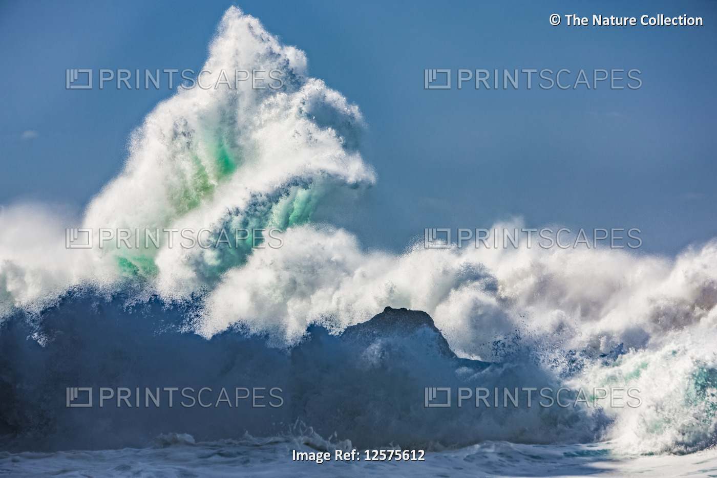 Crashing large wave against a blue sky; Hawaii, United States of America