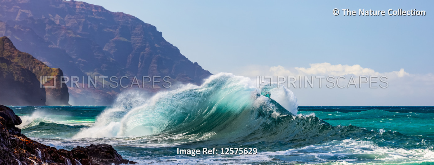 Panorama of large waves crashing into the Na Pali coastline at Ke'e Beach; ...