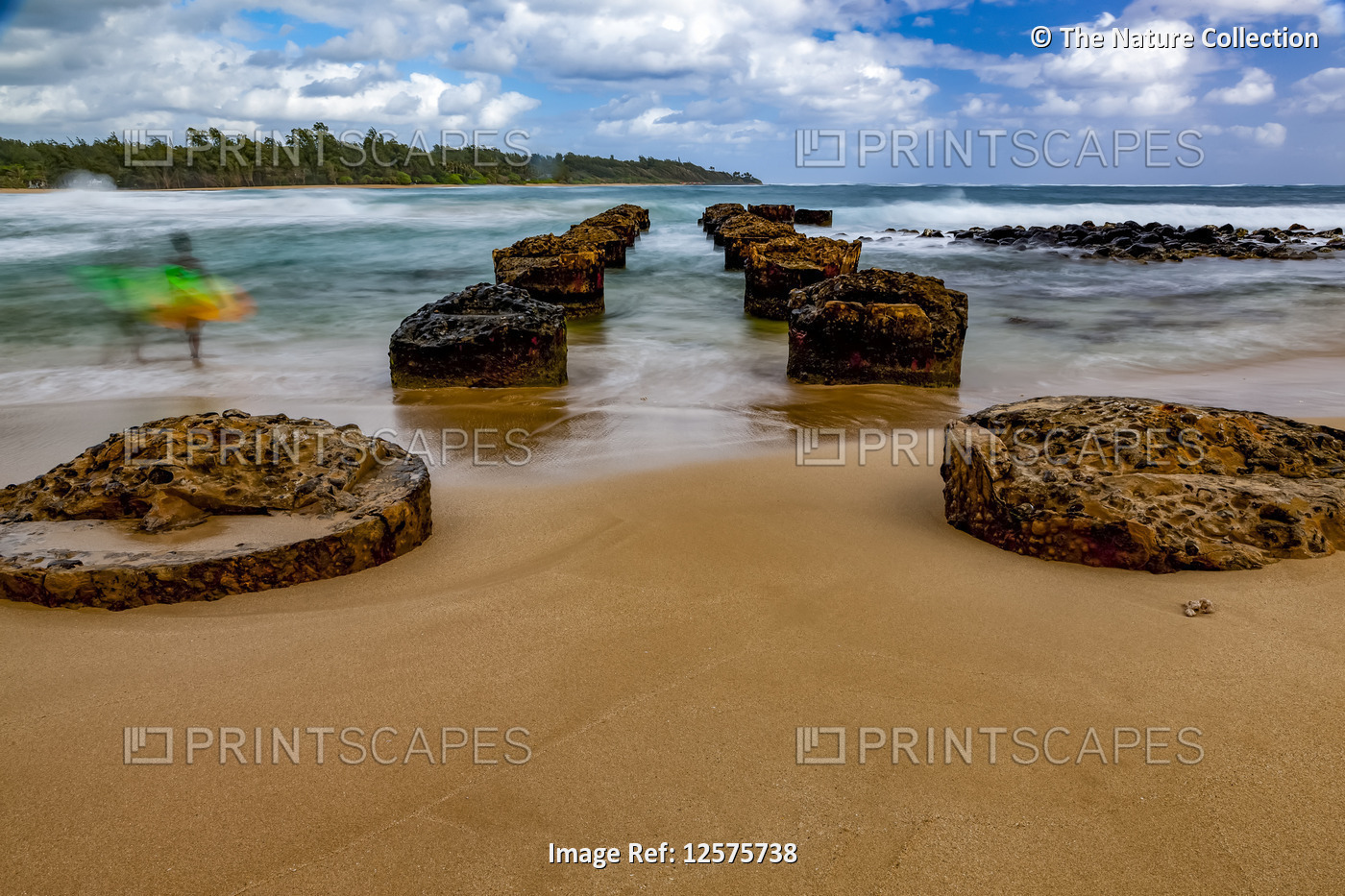 Anahola Beach pier with the blur of a surfer; Kauai, Hawaii, United States of ...
