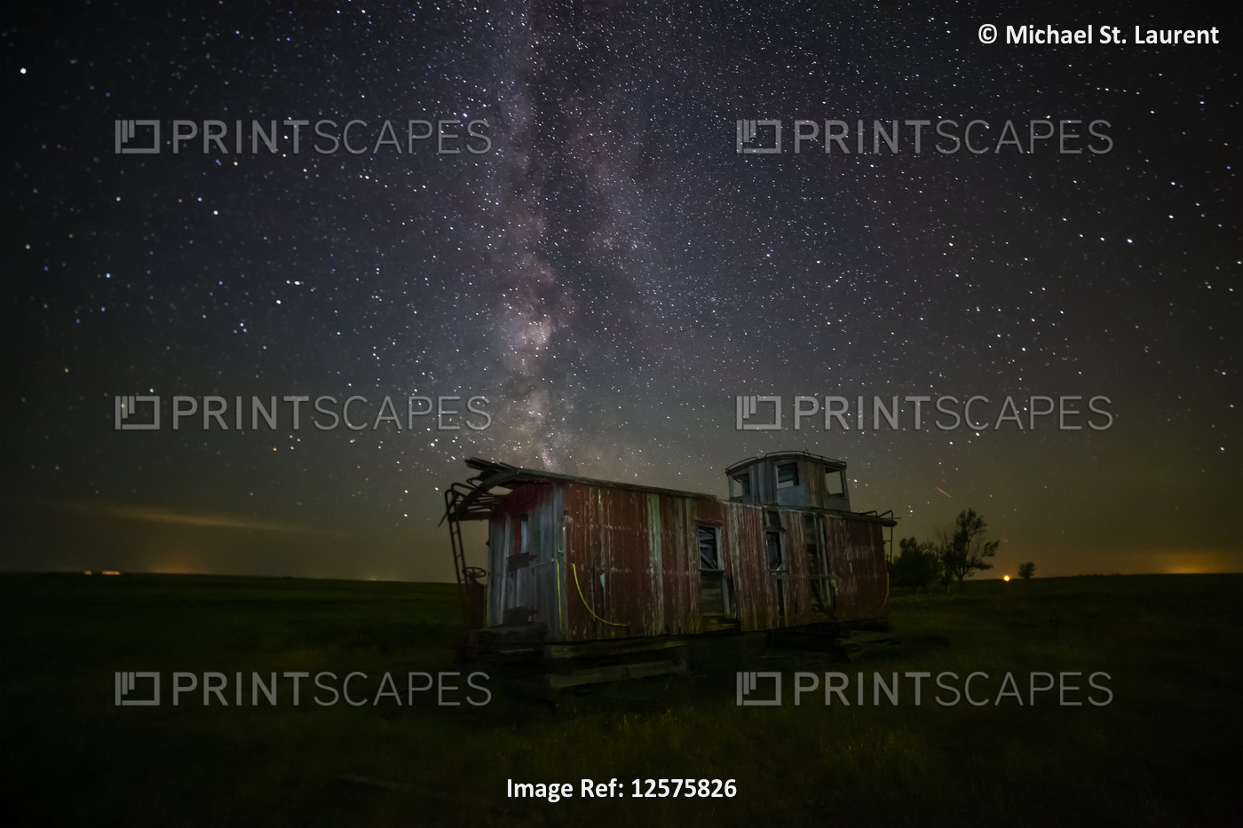 Old caboose at nighttime under a bright, starry sky; Coderre, Saskatchewan, ...