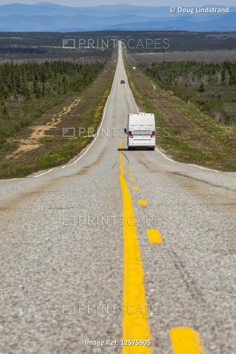 A tour bus travels along a long, lonely stretch of highway between Delta ...