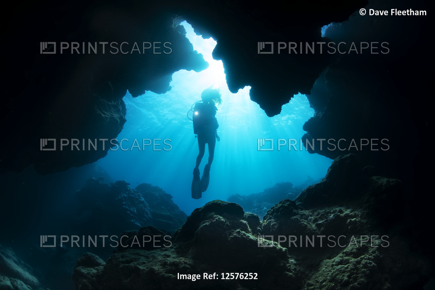 Diver entering a crevice at Yap Cavern's off the very south end of the island ...
