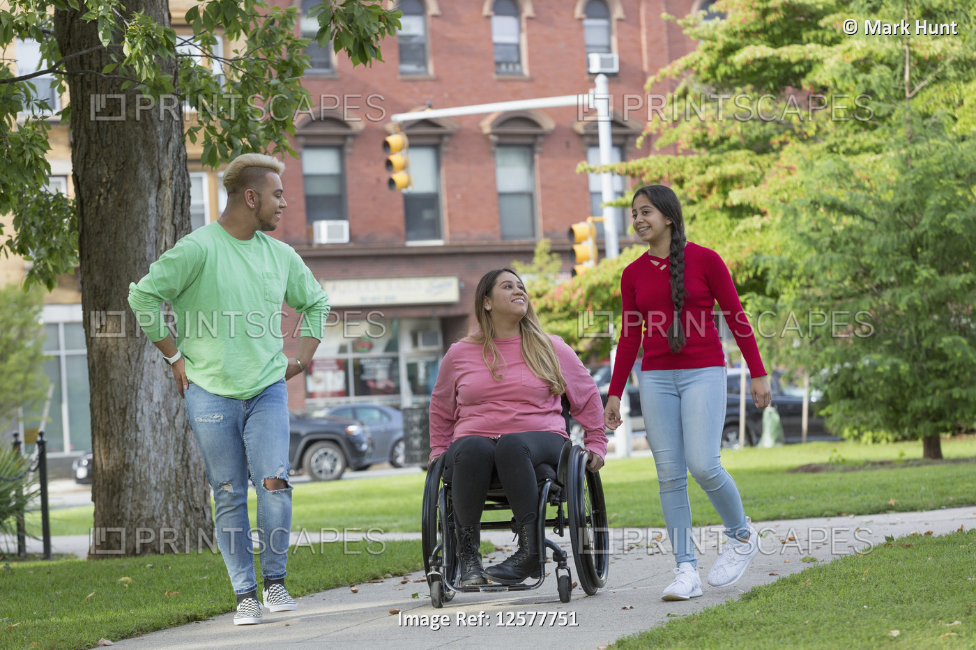 Woman who has Spinal Cord Injury walking with siblings in park