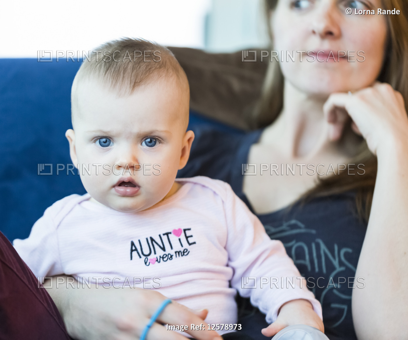 Portrait of infant baby girl with mother at home; Vancouver, British Columbia, ...
