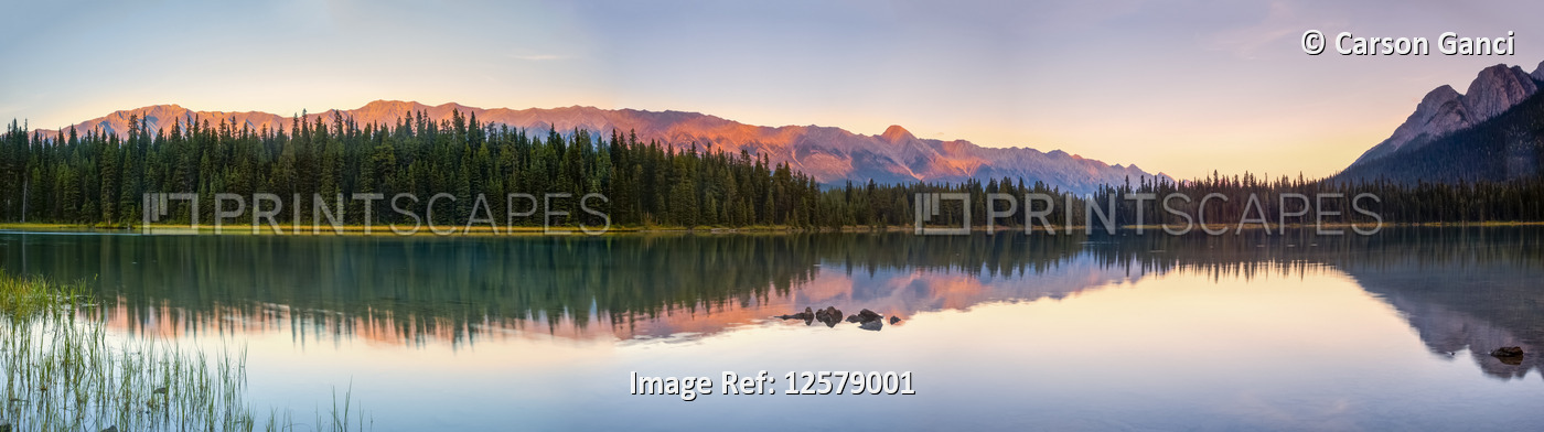 Tranquil lake with reflections in Elk Lakes Provincial Park at sunset; British ...