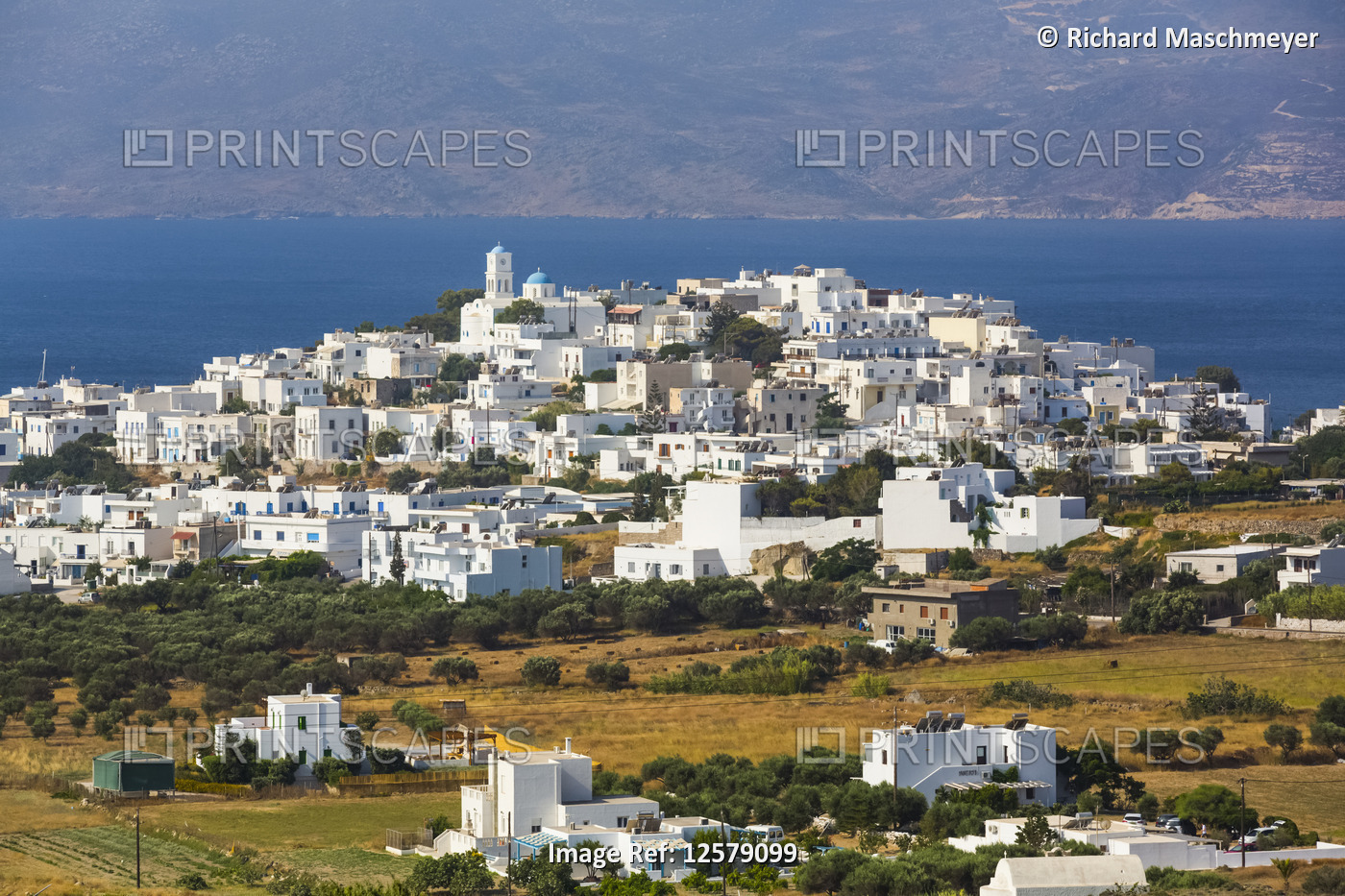 Town on the coast of Milos Island with white buildings and blue sea; Adamas, ...