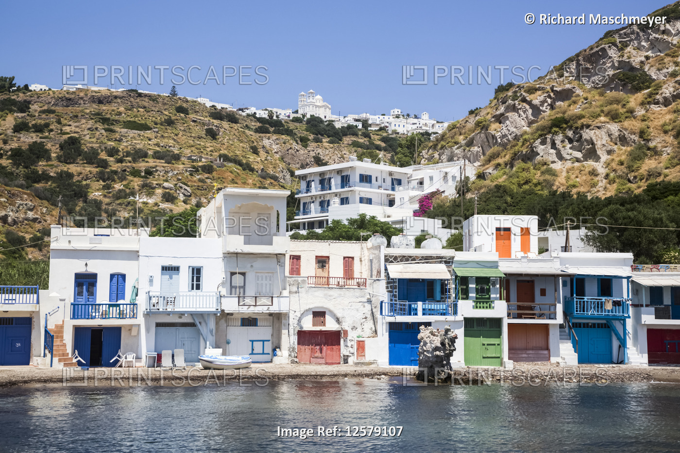 Klima village with white houses and colourful accents along the water's edge; ...