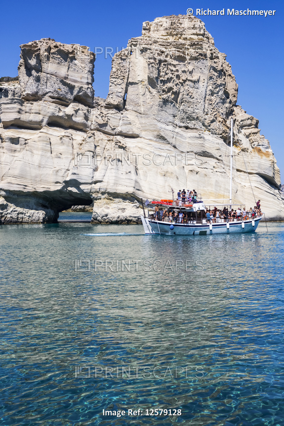 Tourists on tour boat in Kleftiko Bay; Milos Island, Cyclades, Greece