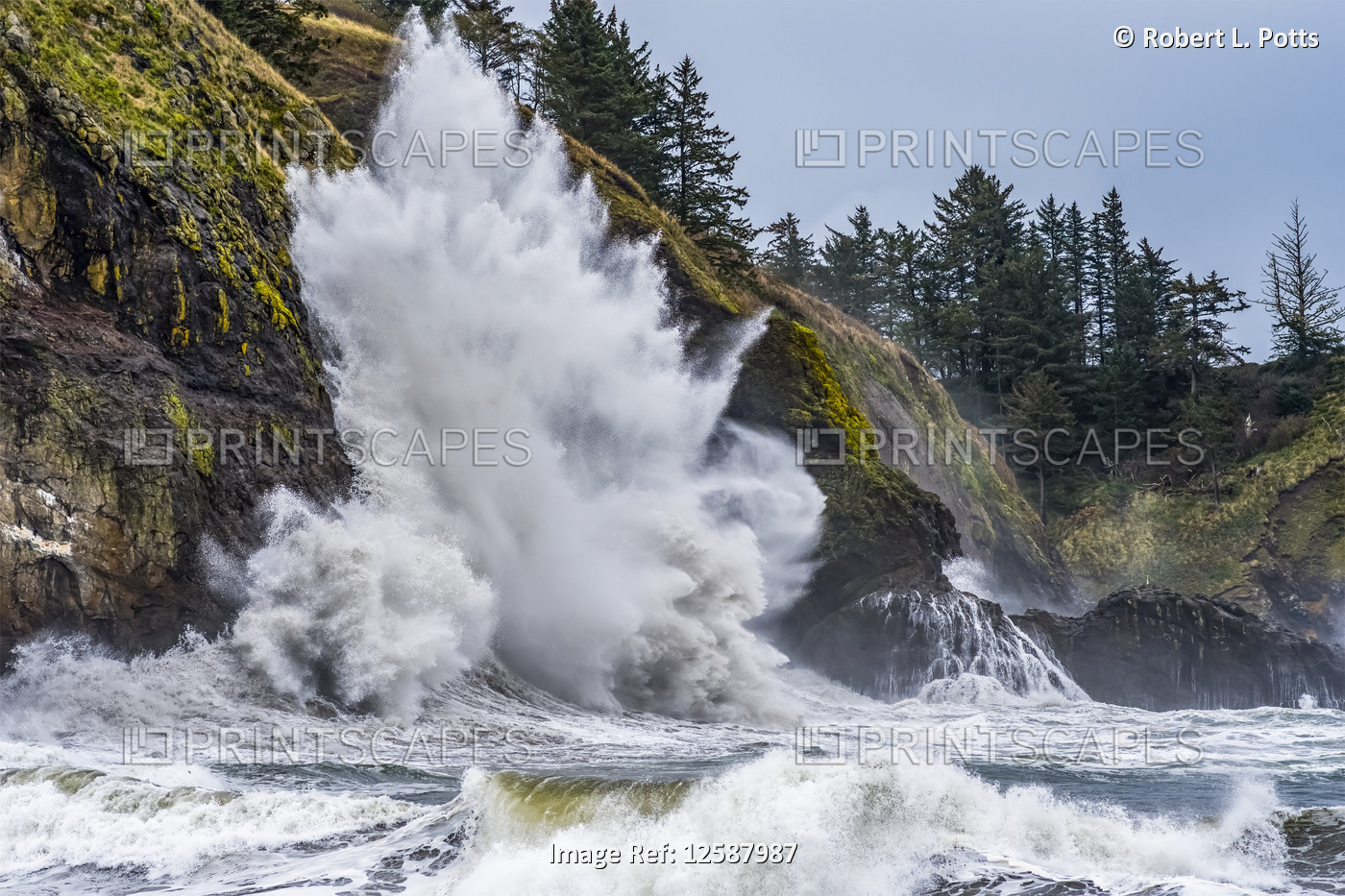 A large wave explodes on the cliffs at Cape Disappointment at the mouth of the ...