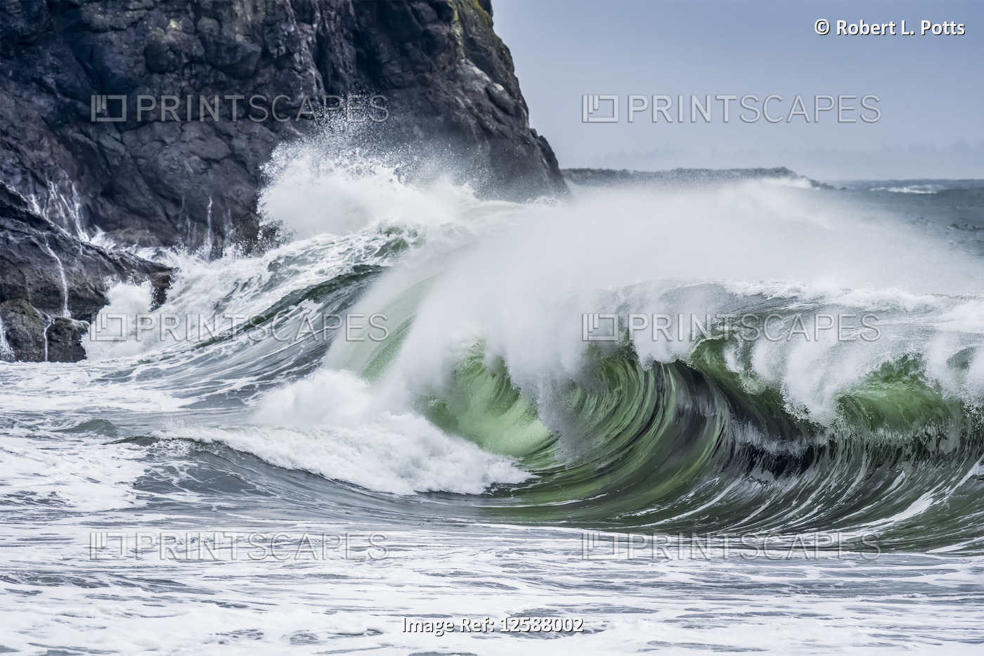 A wave shows its dark interior at Cape Disappointment on the Washington Coast; ...