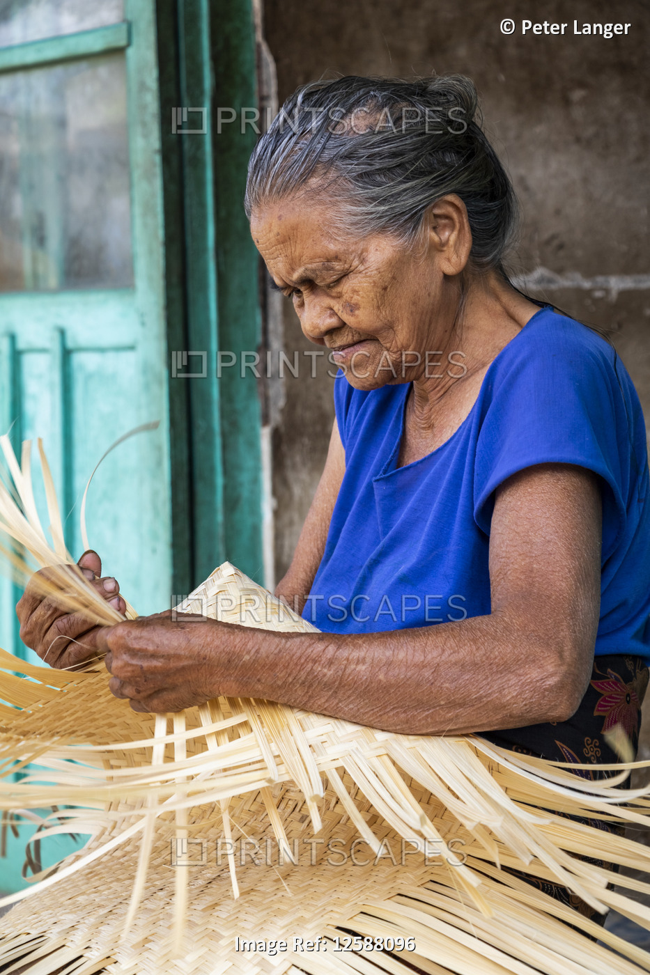 An elderly woman weaving a basket; Sidetapa, Bali, Indonesia