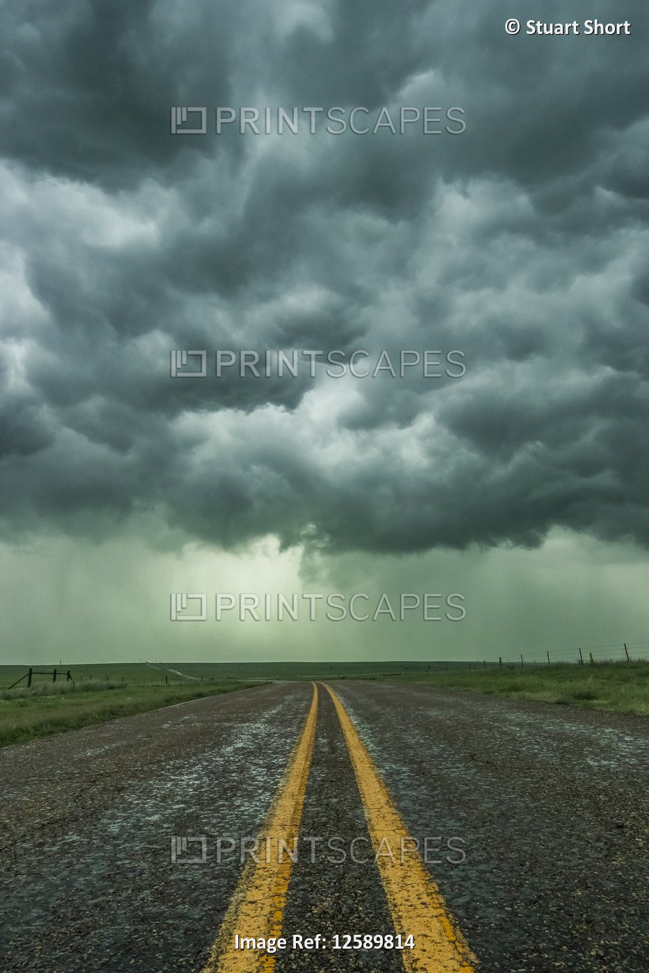 An empty highway disappears into the mouth of a storm somewhere in the Texas ...