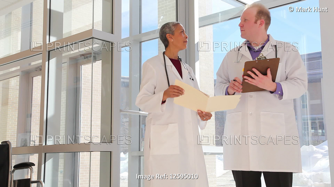 Two doctors consulting in the hospital; Needham, Massachusetts, United States ...