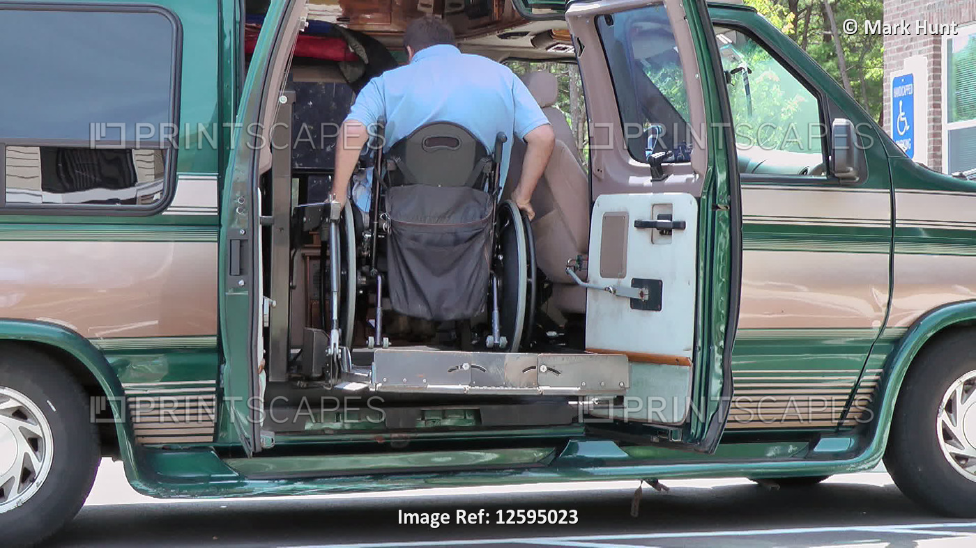 Man with spinal cord injury boarding accessible van; Plymouth, Massachusetts, ...