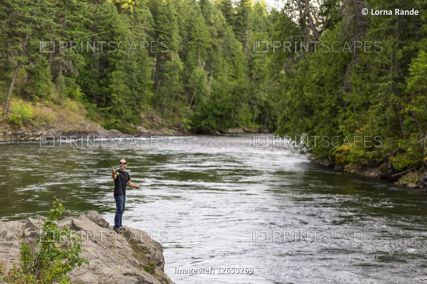 A man fly fishing on Adams River, near Salmon Arm; British Columbia, Canada