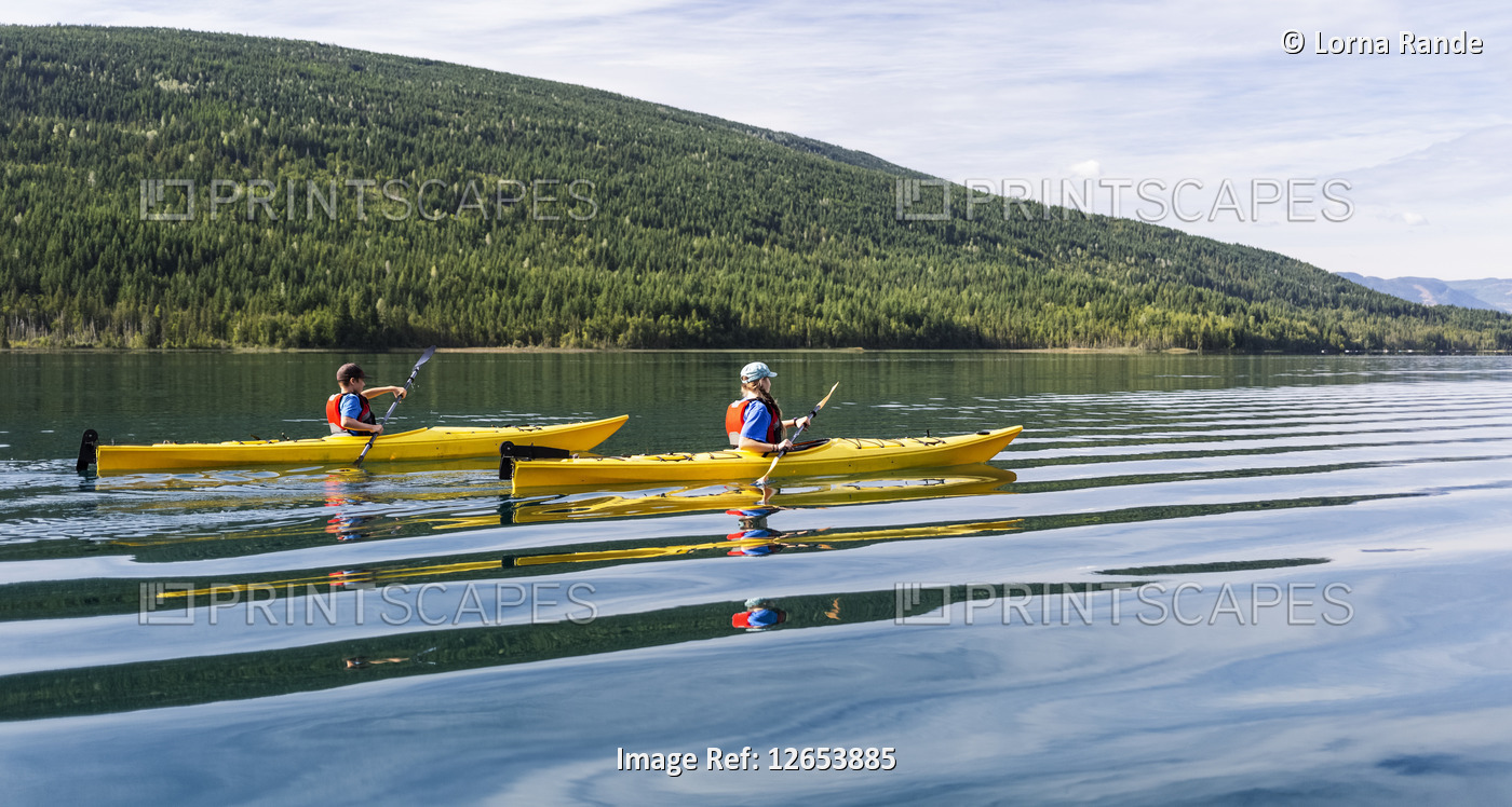 Brother and sister kayaking on White Lake, White Lake Provincial Park; British ...