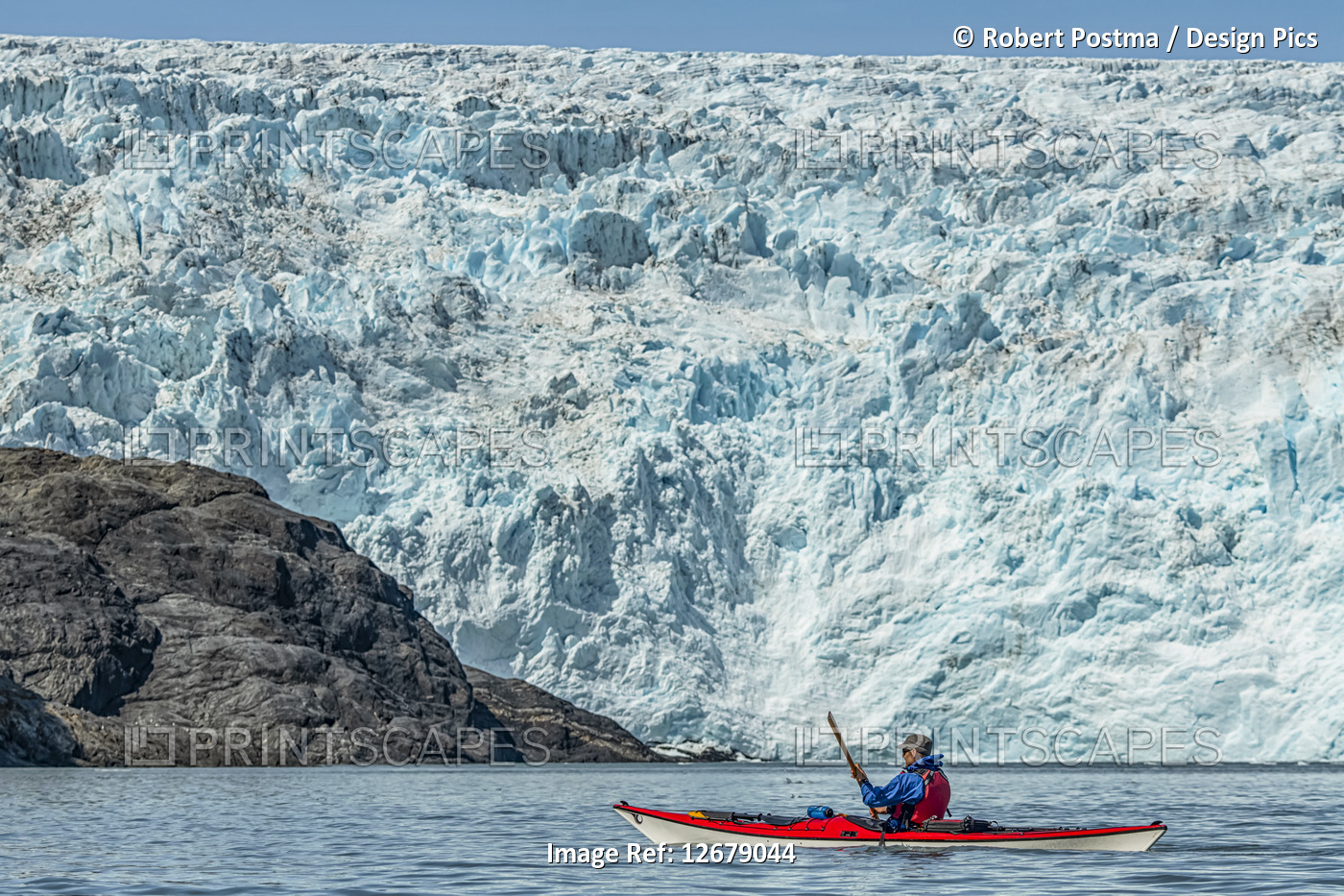 Kayaker in front of a tidewater glacier in Prince William Sound; Alaska, United ...