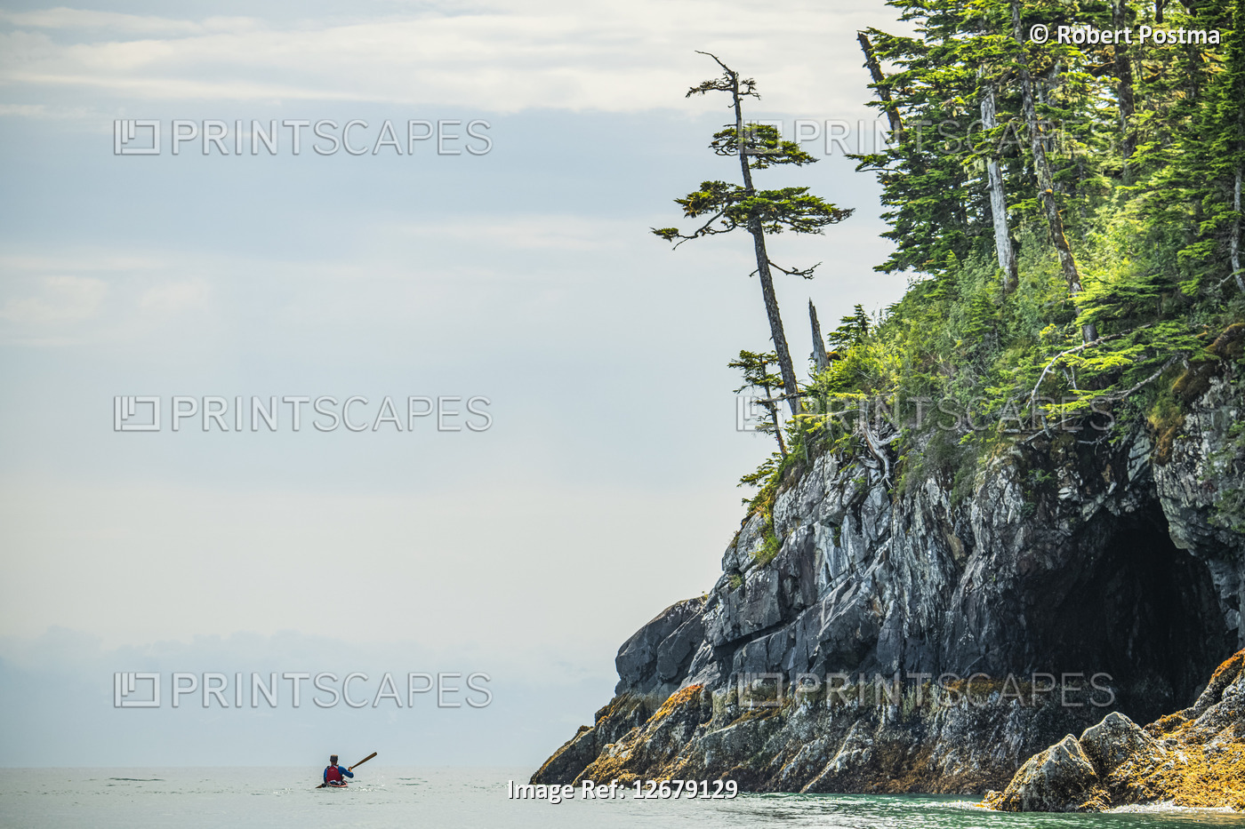 Kayaker paddling through the calm waters in the beautiful scenery of Prince ...