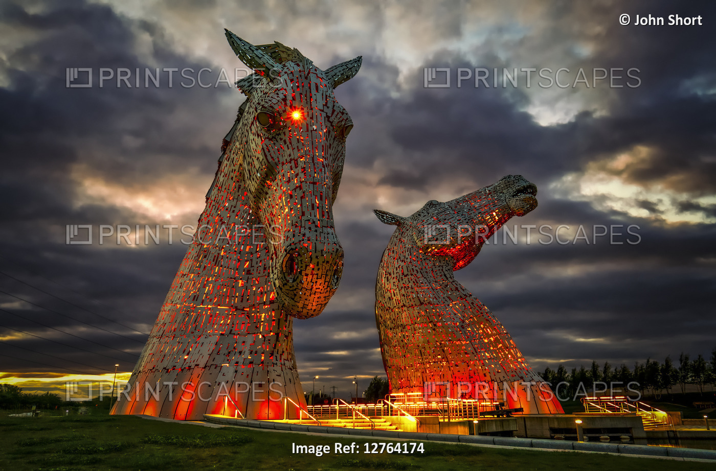 The Kelpies by Andy Scott, illuminated by light at dusk; Falkirk, Forth Valley, ...