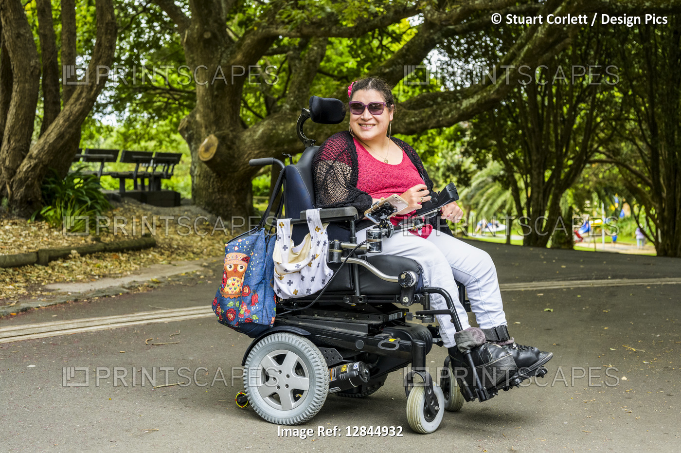 Maori woman with Cerebral Palsy in a wheelchair in a park area; Wellington, New ...