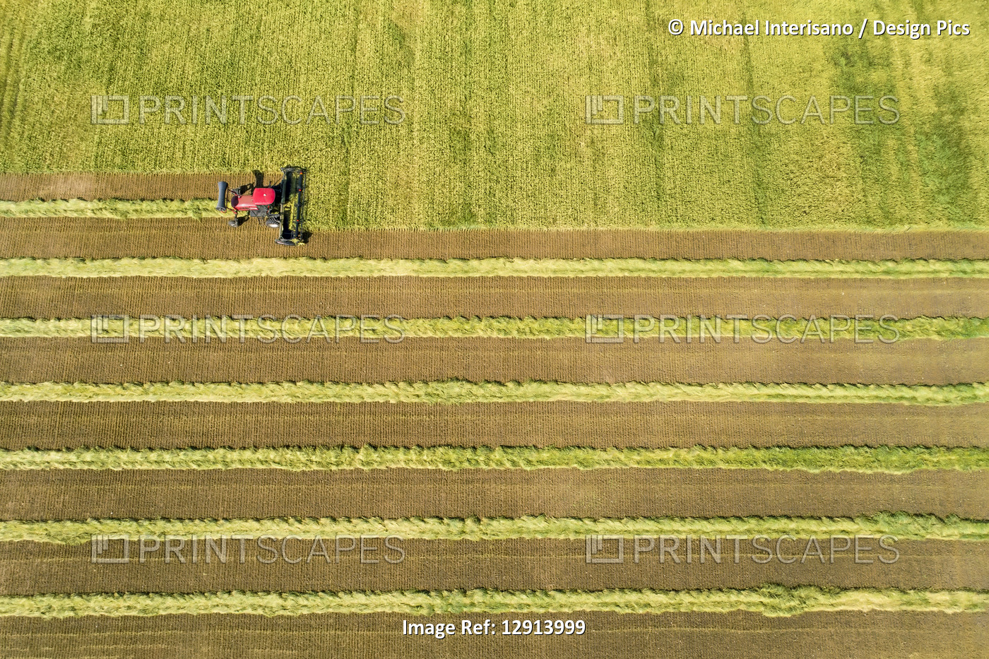 View from directly above of a swather cutting a barley field with graphic ...