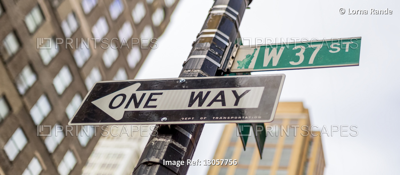 Street signs on a post, a directional one way and West 37th Street, Manhattan; ...