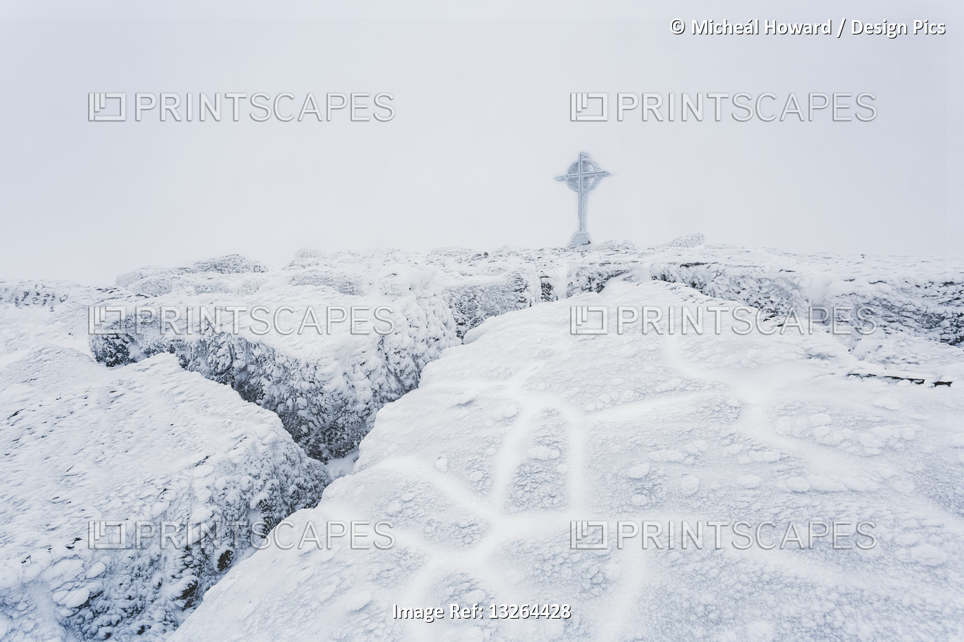 Frozen ice formations on the summit of Galtymor mountain with a celtic cross in ...