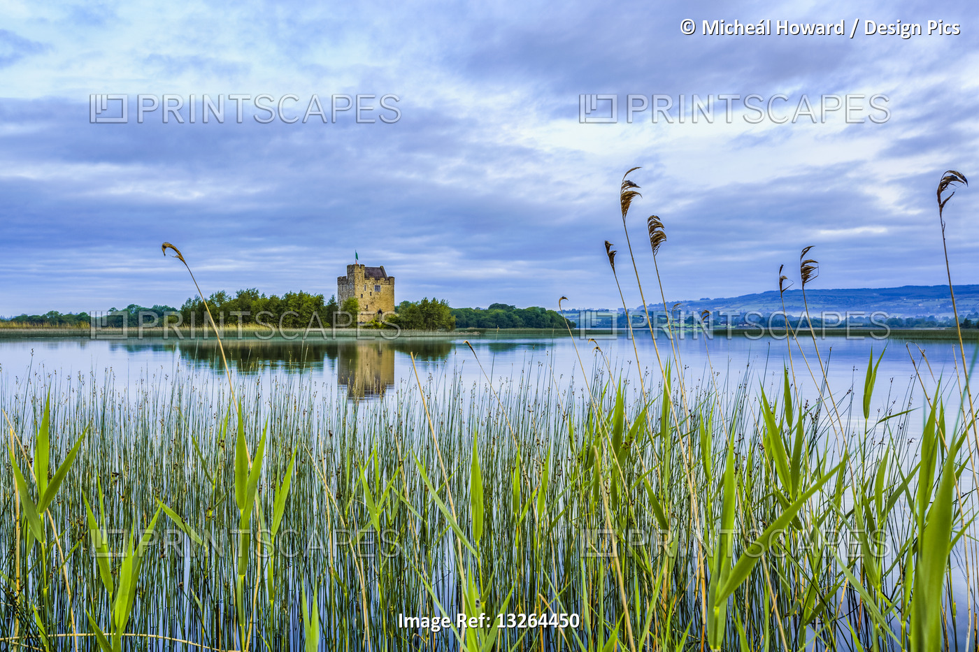 Castlebawn castle on the shore of Lough Derg reflecting in the water on a calm ...