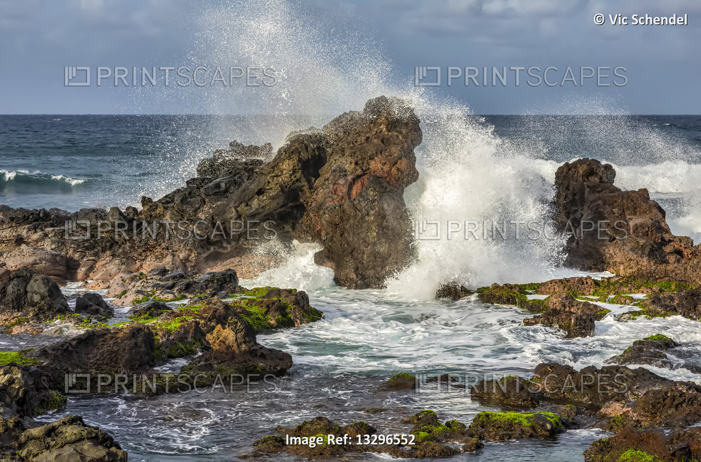 Waves crash on rugged coastline of Maui, Hawaii, USA