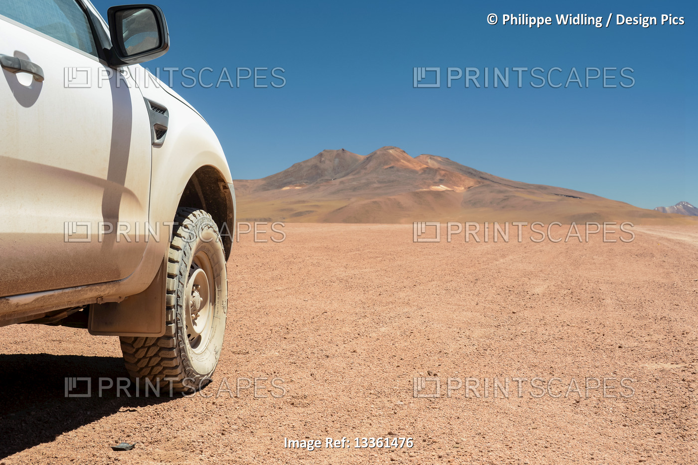 Four-wheel drive vehicle seen from the side and showing off-road tire with high ...