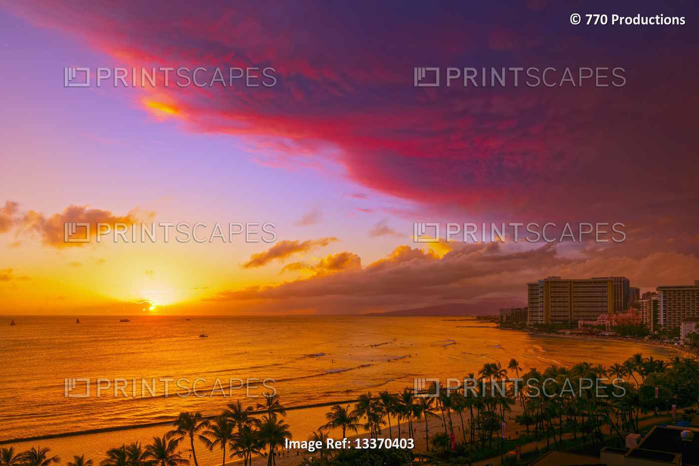 Waikiki Beach in vibrant colours at sunset with a dramatic glowing cloud ...
