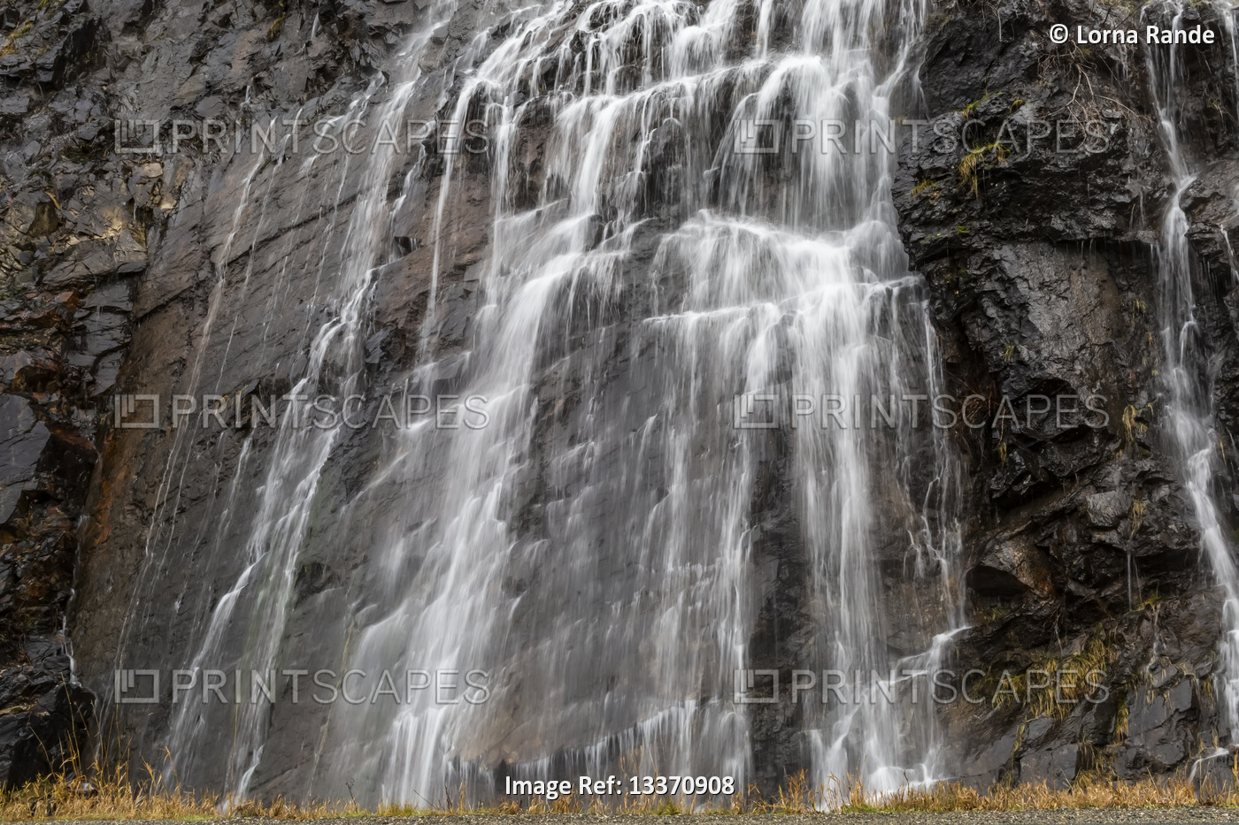 Splashing waterfall over rugged rock wall, Village of Harrison Hot Springs; ...