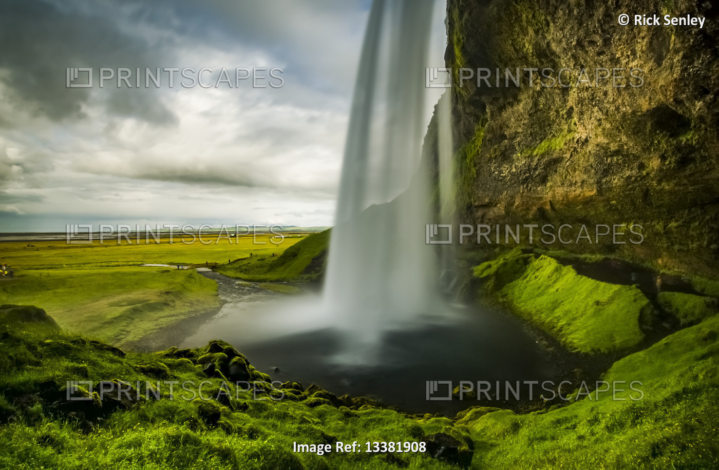 View of a rushing waterfall taken from behind, Seljalandsfoss; Iceland