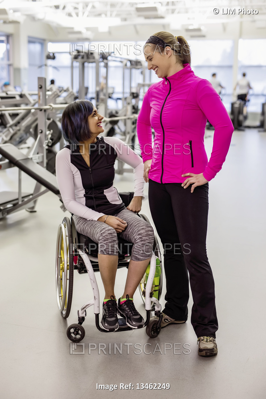 A paraplegic woman talking with her personal trainer and her trainer after a ...