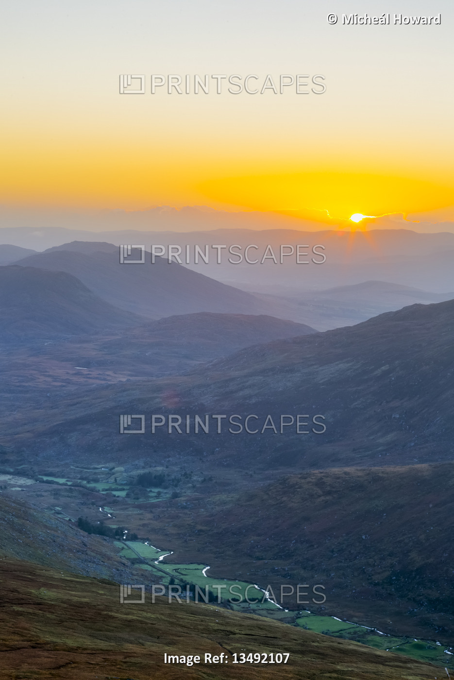Sun rising over the Owenreagh River in the Gearsallagh Valley in ...