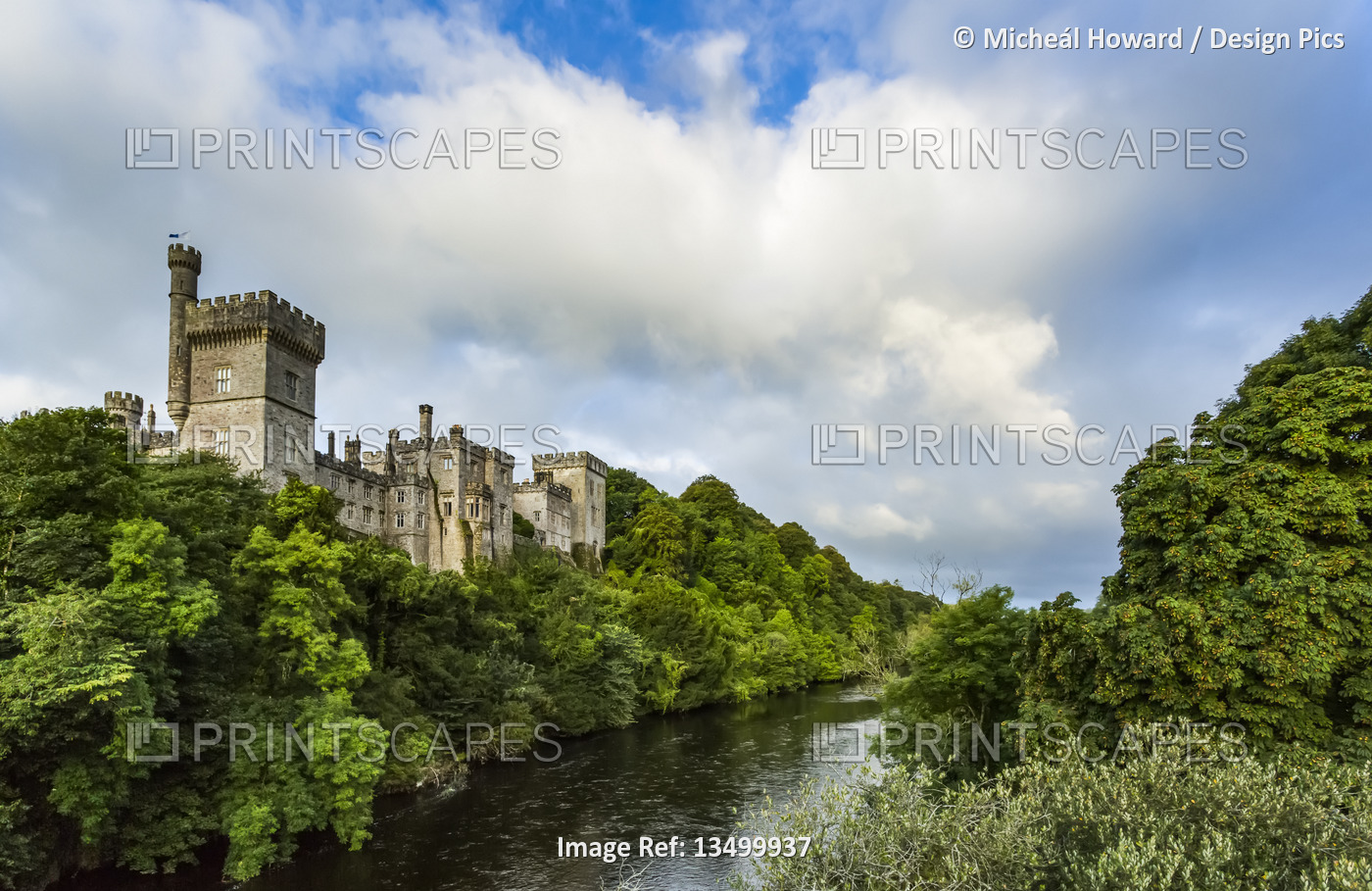 Lismore castle overlooking the Blackwater river in summer on a cloudy day; ...