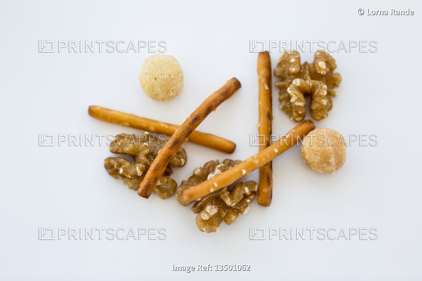 Snack mix of nuts and pretzel sticks on a white background; Studio