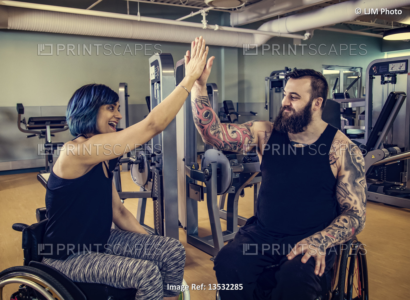 Two paraplegic friends giving each other a high five after working out at a ...