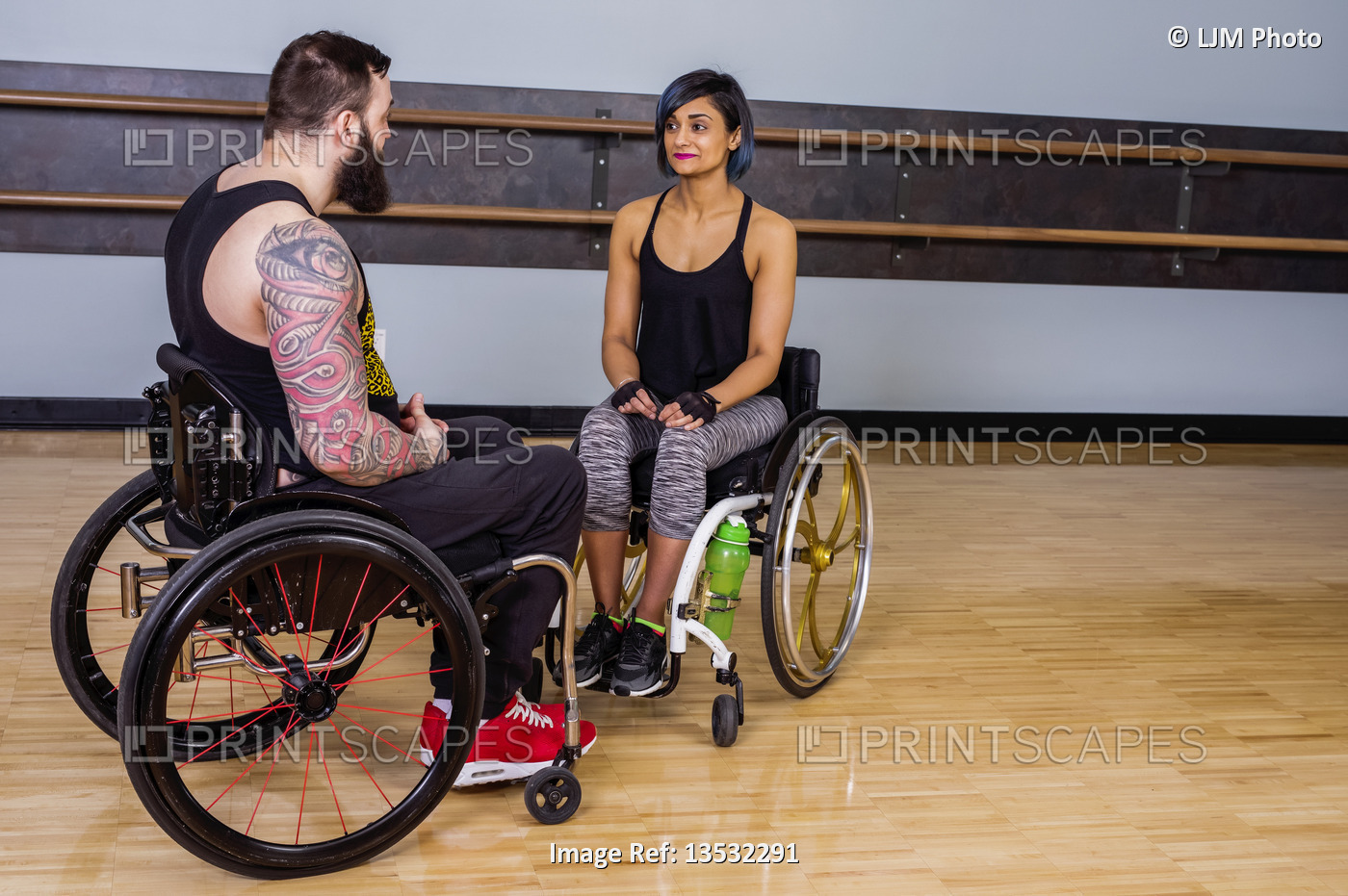 Two paraplegic friends talking together and encouraging each other after ...