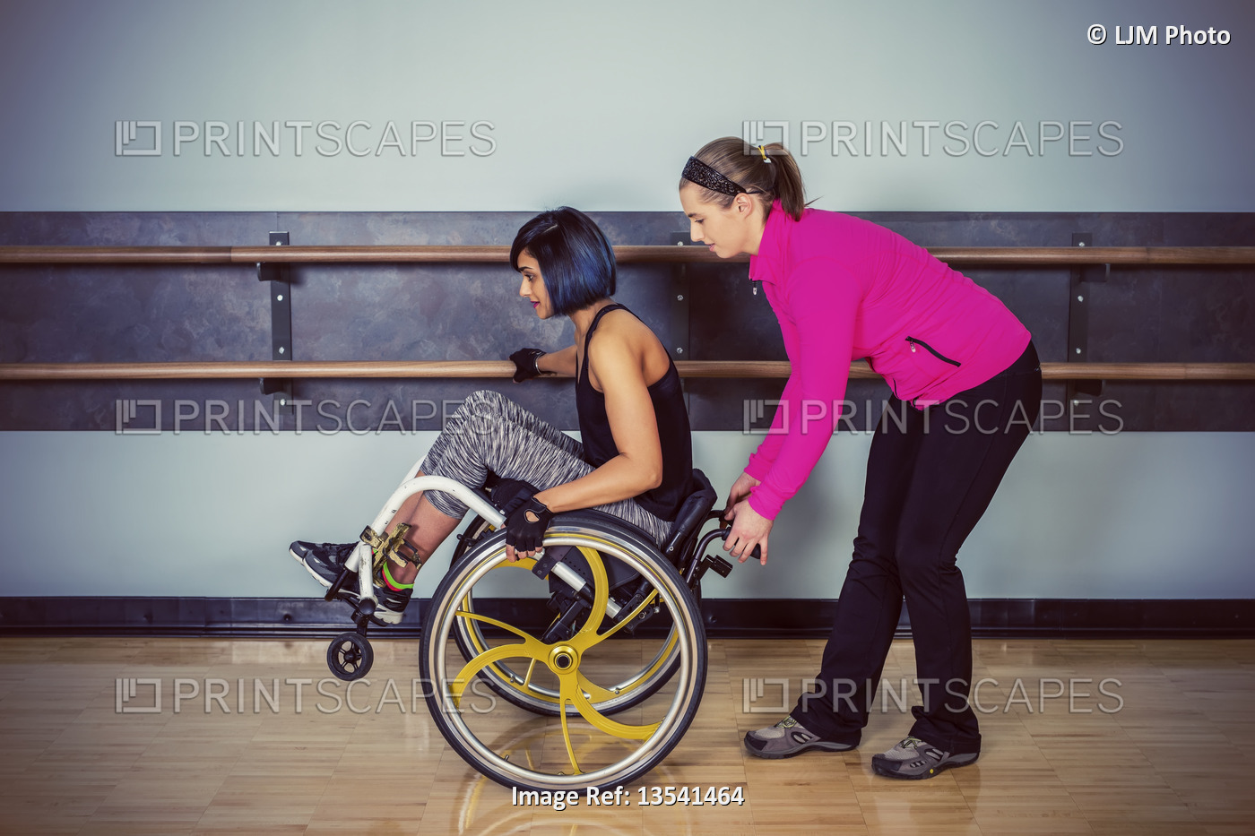 A paraplegic woman popping wheelie in her wheelchair and fooling around in a ...