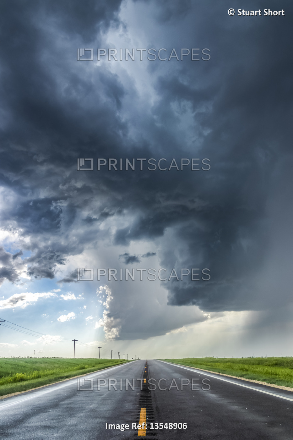 A developing severe thunderstorm with large hail crosses the highway in ...