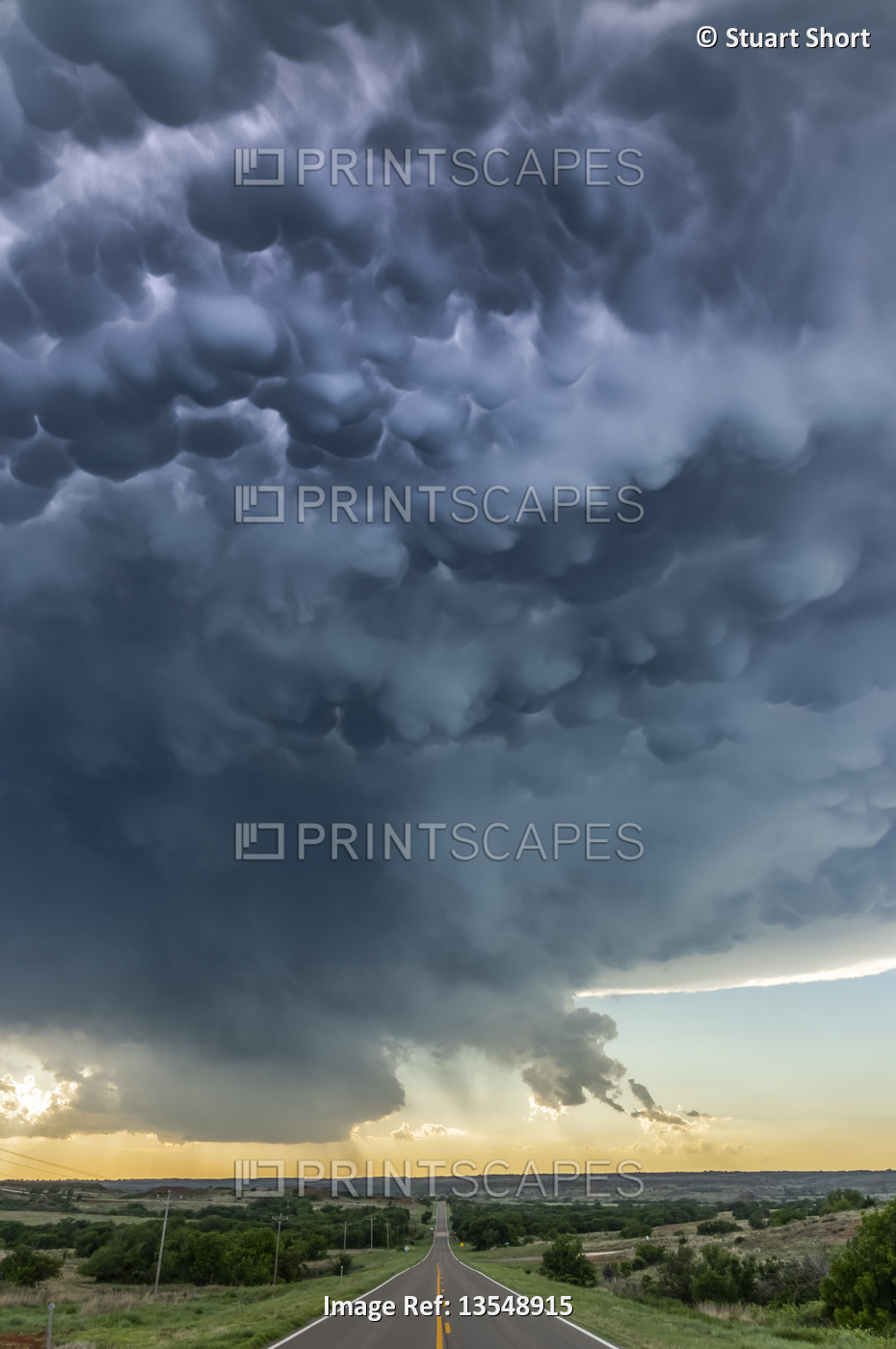 Mammatus from a collapsing severe thunderstorm is lit up by lightning as it ...