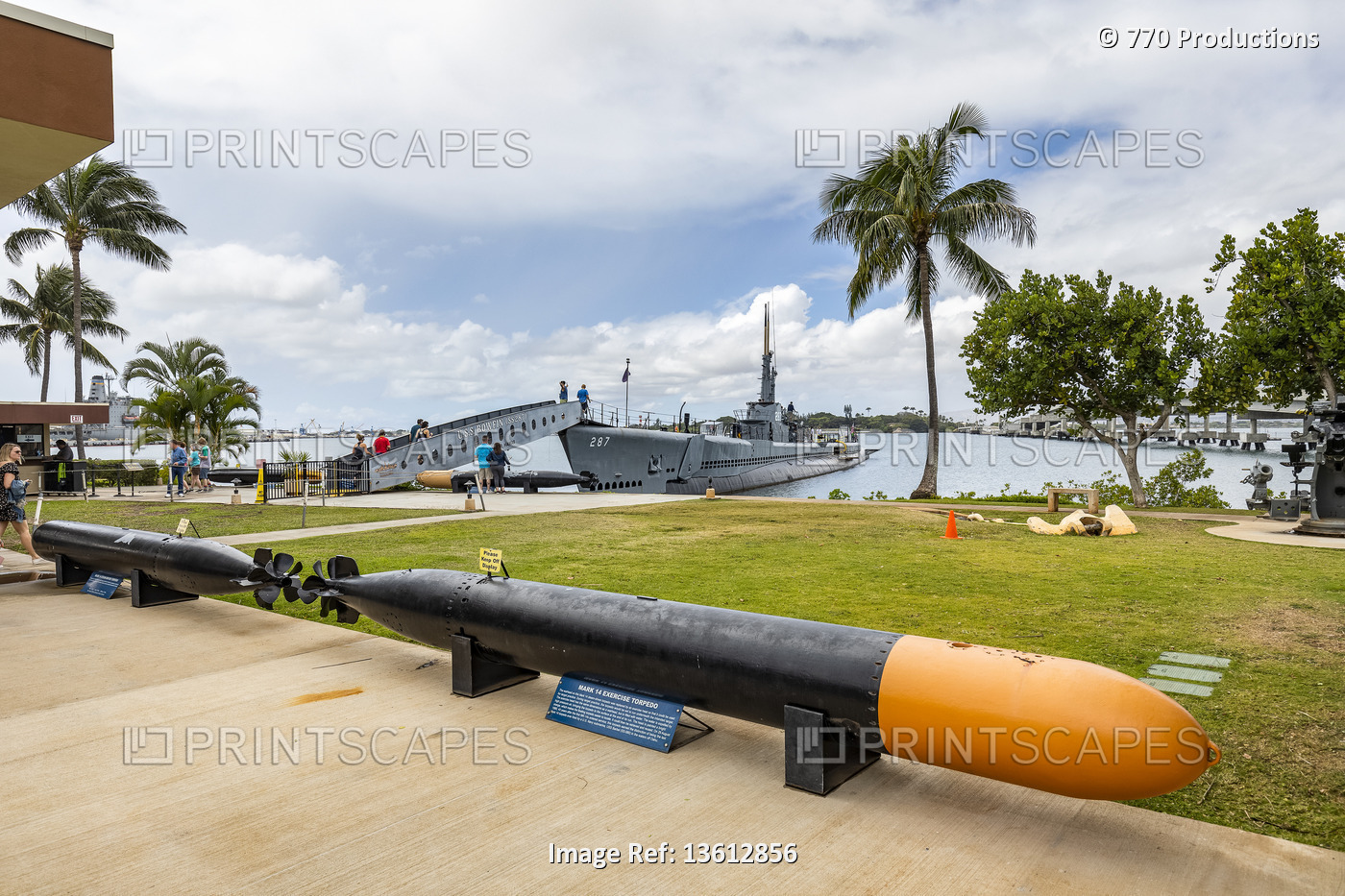 Torpedo display and tourists exploring a submarine at Pearl Harbour; Oahu, ...