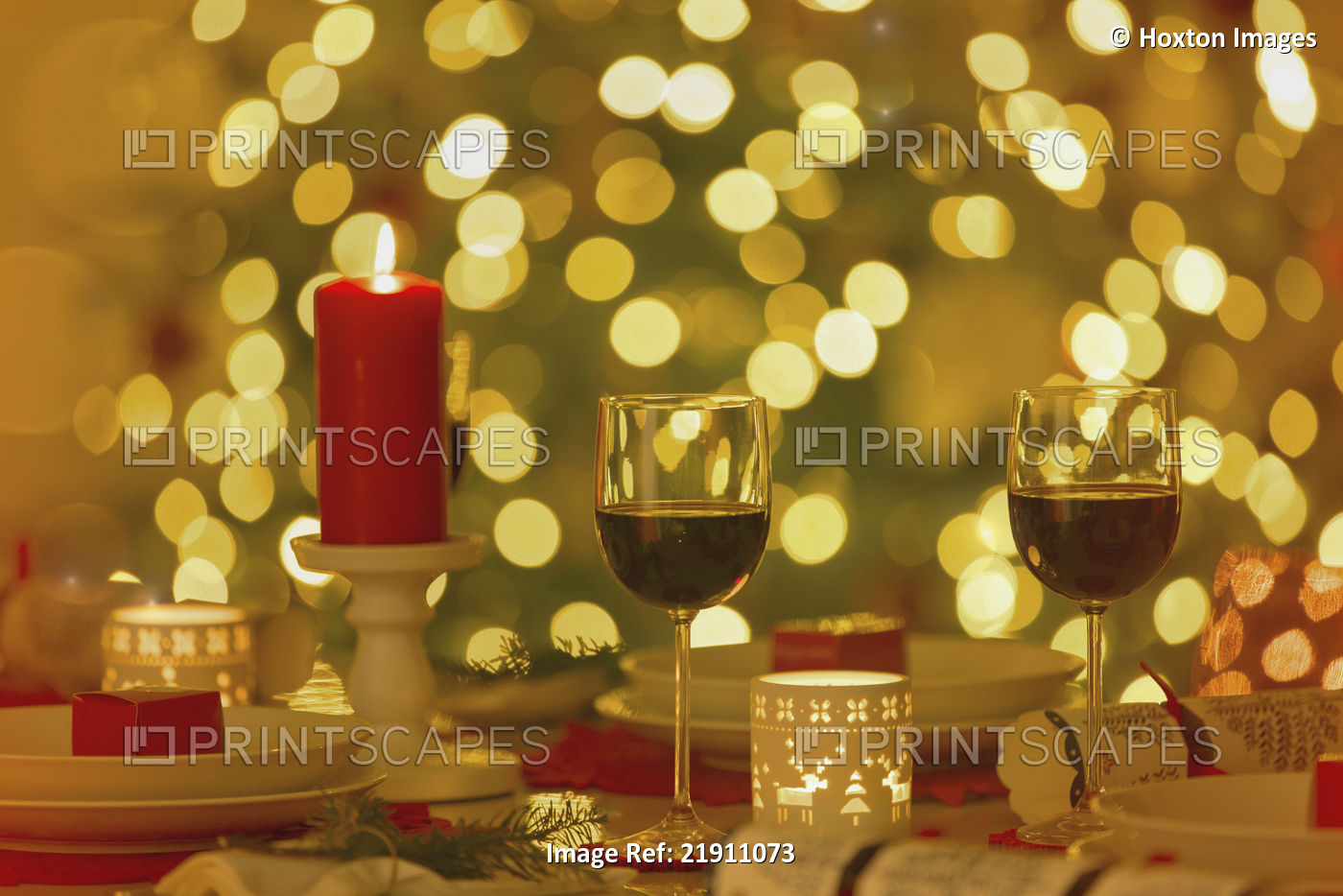 Red wine and candles on ambient Christmas dinner table