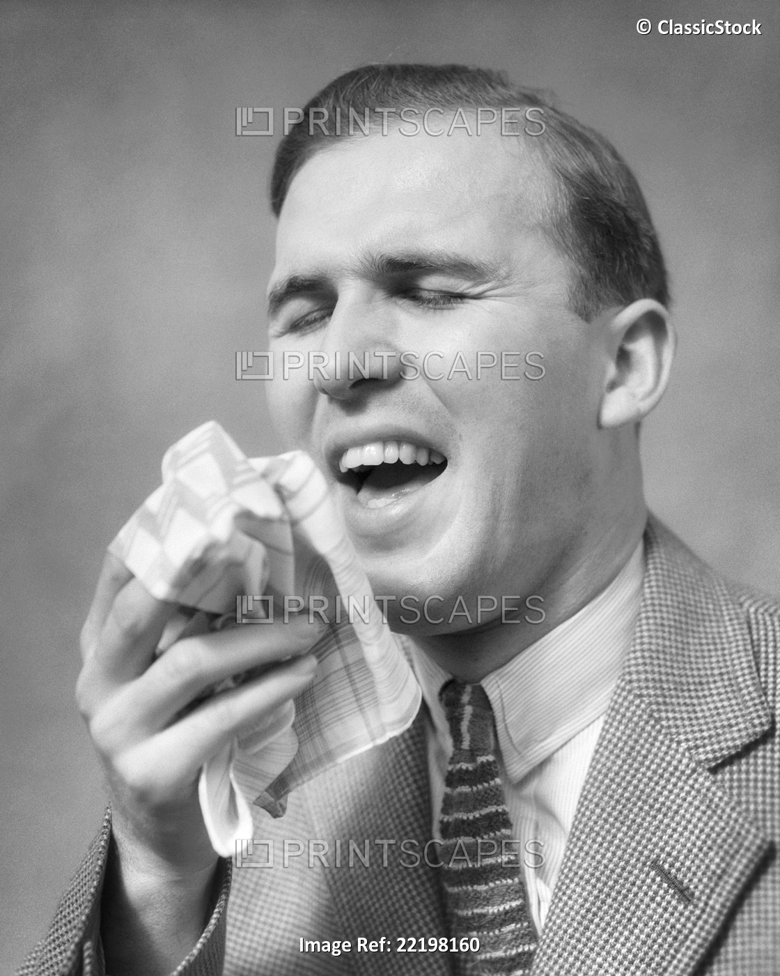 1930s MAN EYES CLOSED MOUTH OPEN HANDKERCHIEF IN HAND ABOUT TO SNEEZE