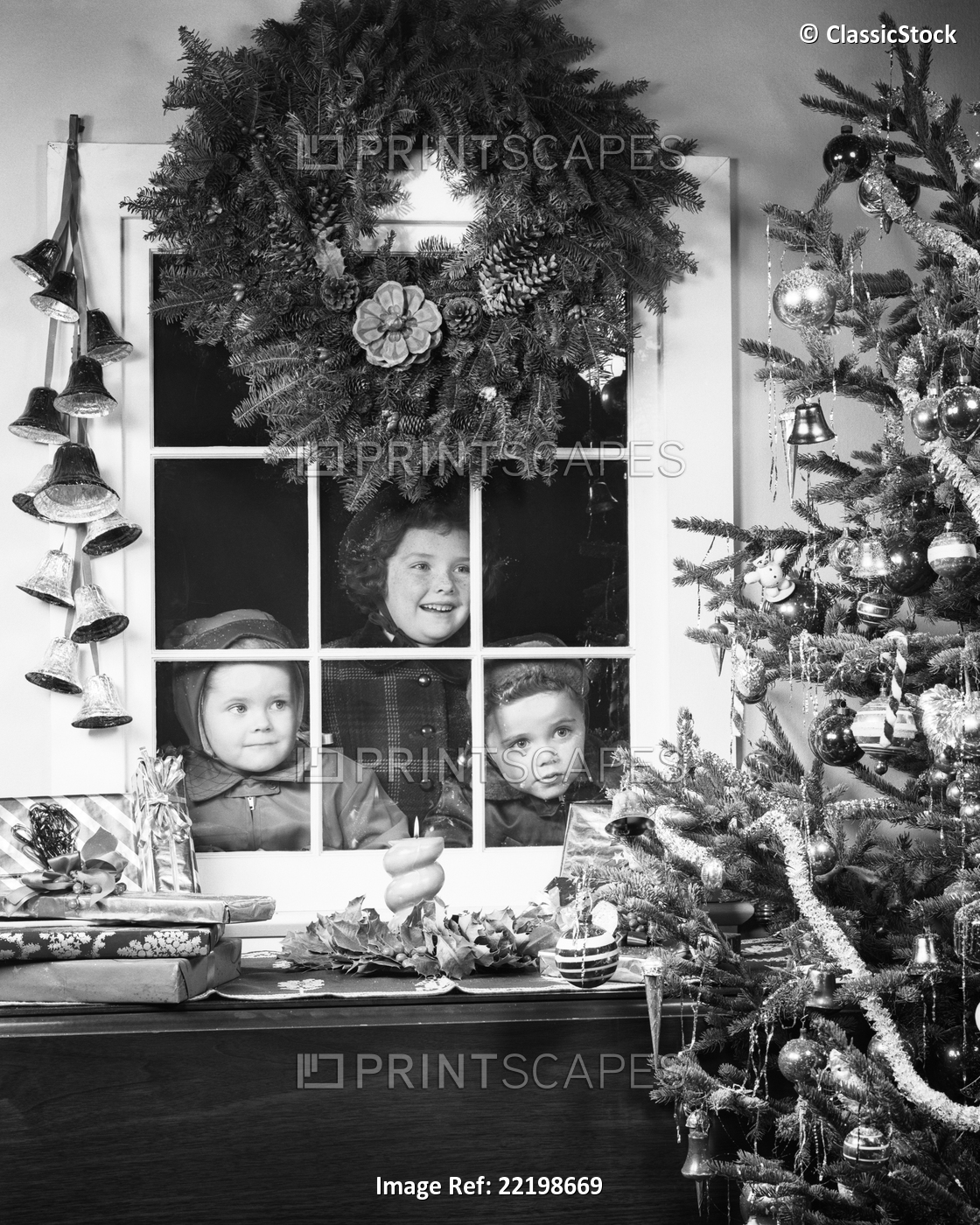 1950s CHILDREN ONE GIRL TWO BOYS LOOKING THROUGH WINDOW AT CHRISTMAS TREE WITH ...