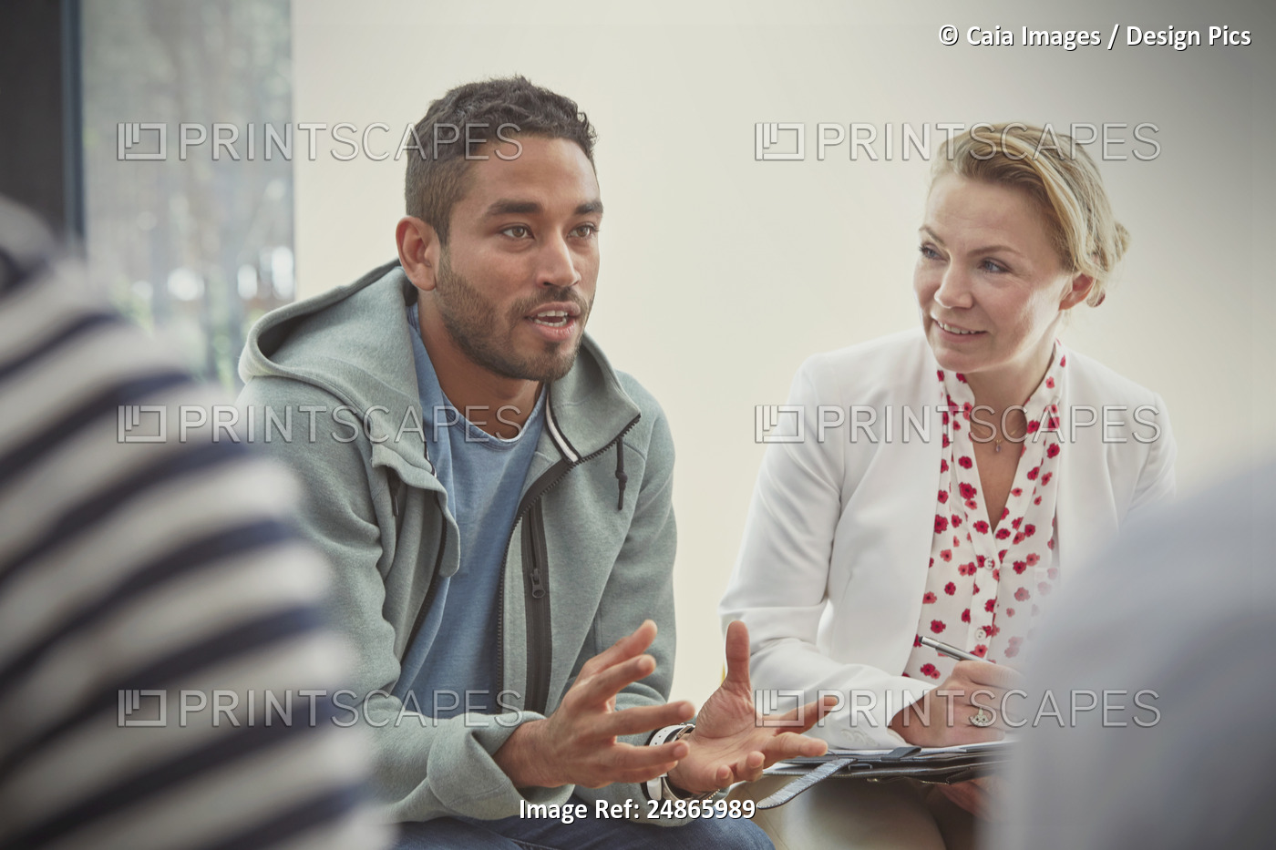 Young man talking in group therapy session