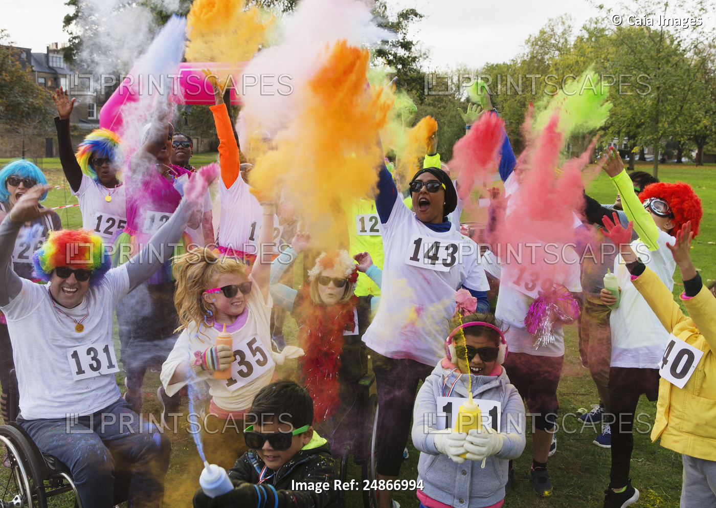 Playful charity run runners celebrating with holi powder in park
