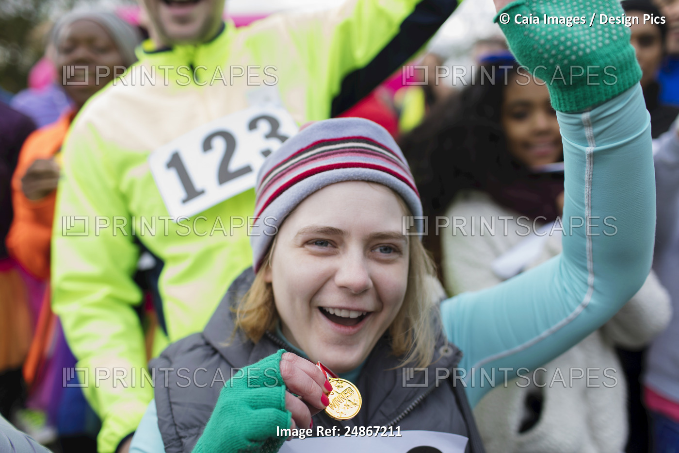 Enthusiastic woman with medal cheering at charity race