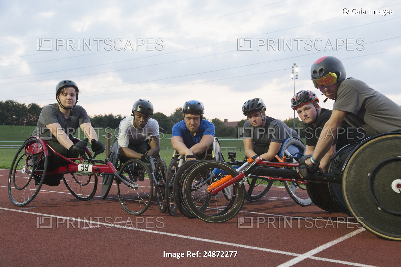 Portrait confident, determined paraplegic athletes training for wheelchair race ...